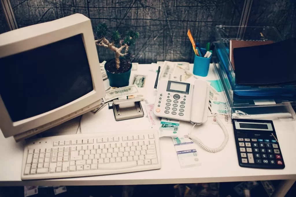 Old computer and calculator in office.