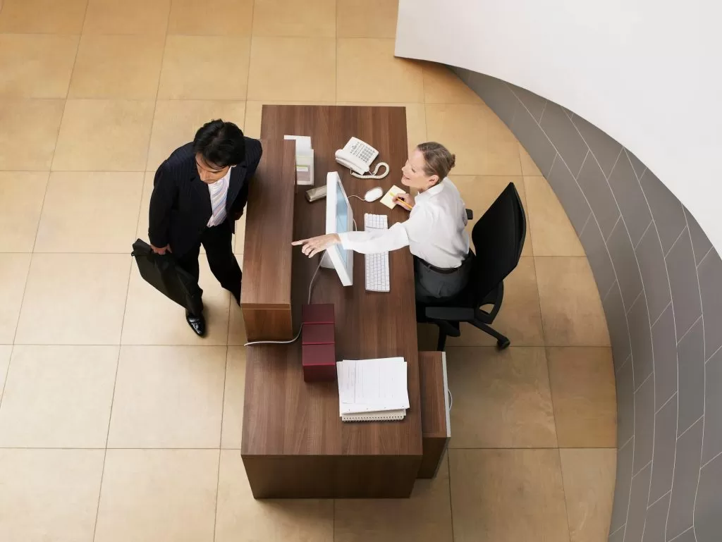 Receptionist directing visitor