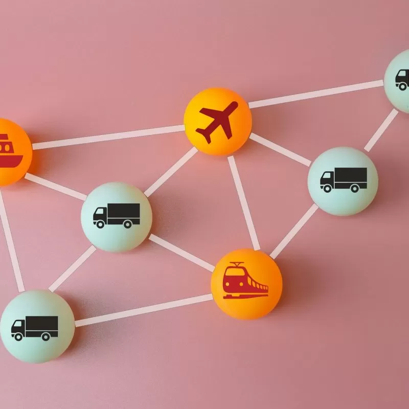 Connected logistics and supply chain concept. Table tennis ball with plane, trucks, train and ship s