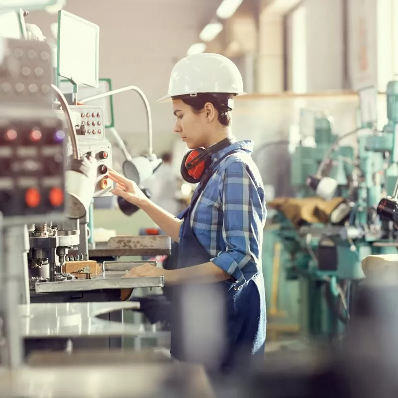 Woman operating manufacturing machine